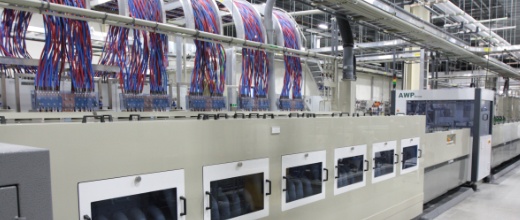 Automated production line with cable management system in a modern manufacturing facility.