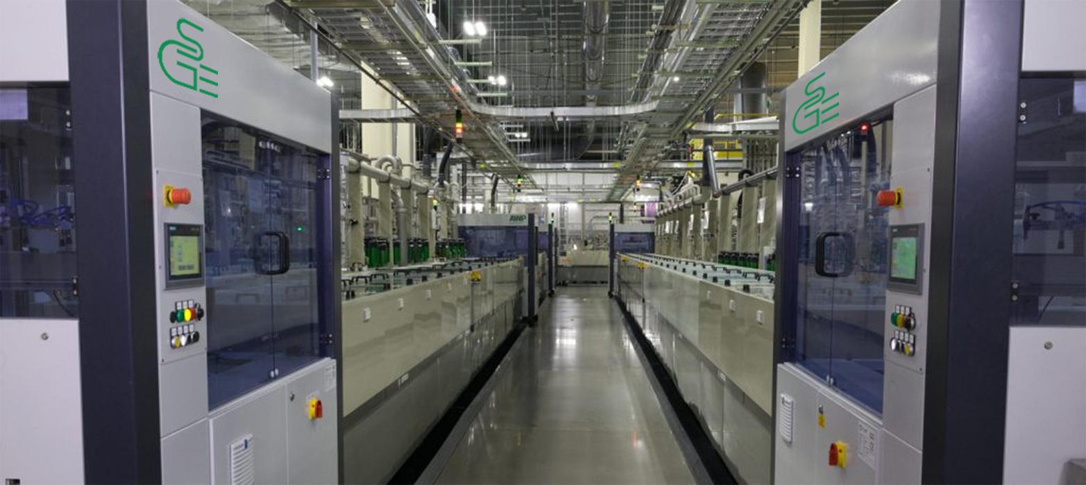 A modern manufacturing facility with rows of high-tech equipment.